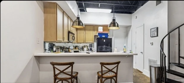 Kitchen and spiral stair in a loft-style residence