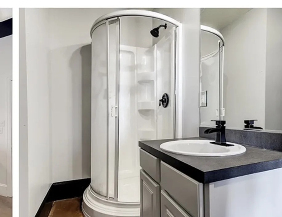 Bathroom with curved shower enclosure